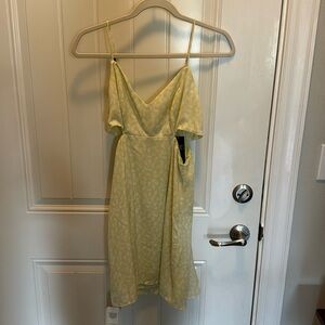 Light green yellow dress. Has side cut outs with adjustable straps.